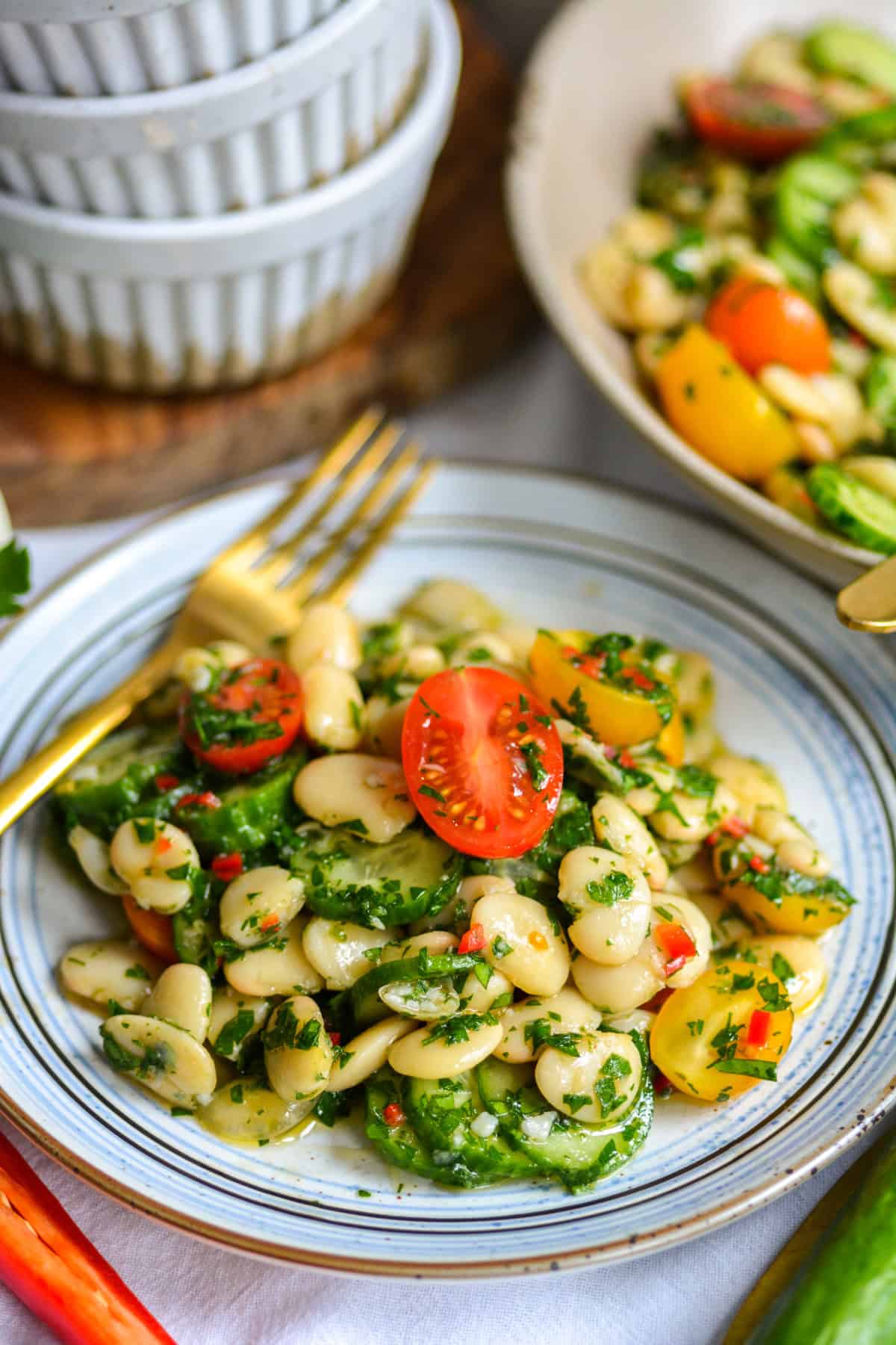 Butter Bean Salad on a plate with a gold fork.