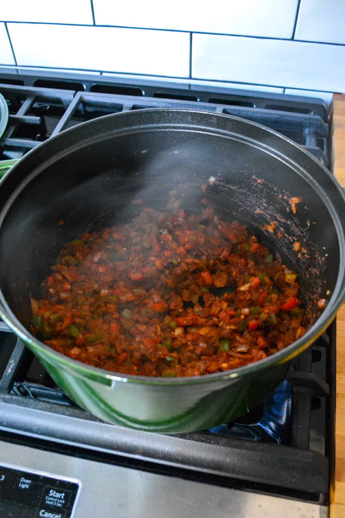 Tomato paste and spices added into the large pot.