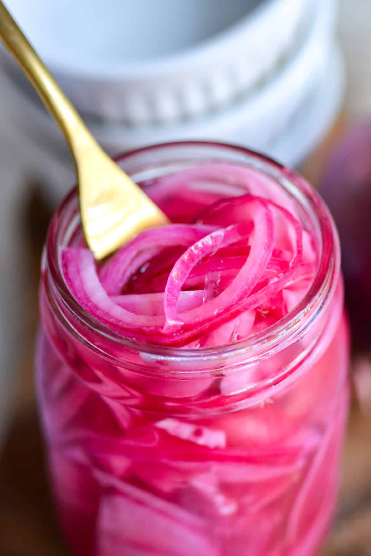 Quick Pickled Red Onions in a glass jar.