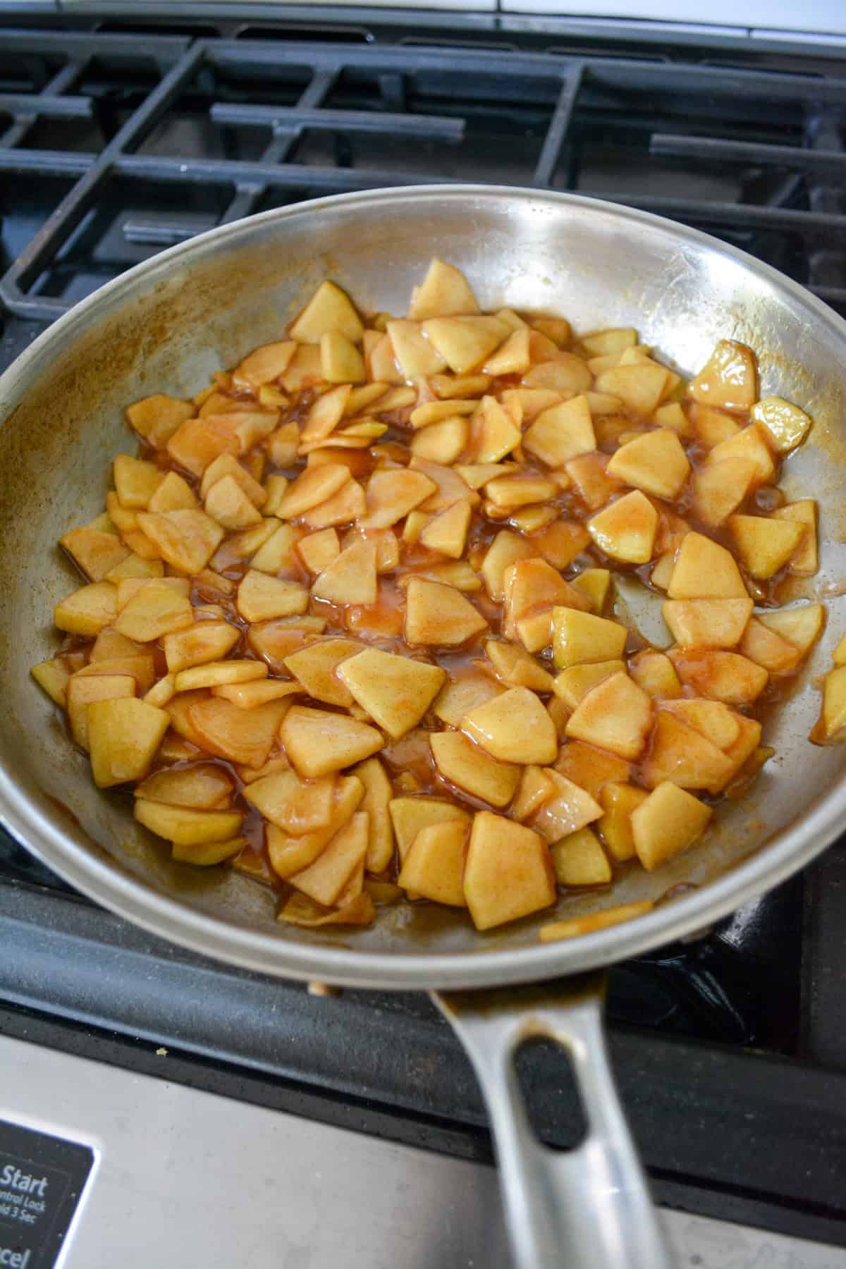 Apple cinnamon filling in a stainless steel skillet.