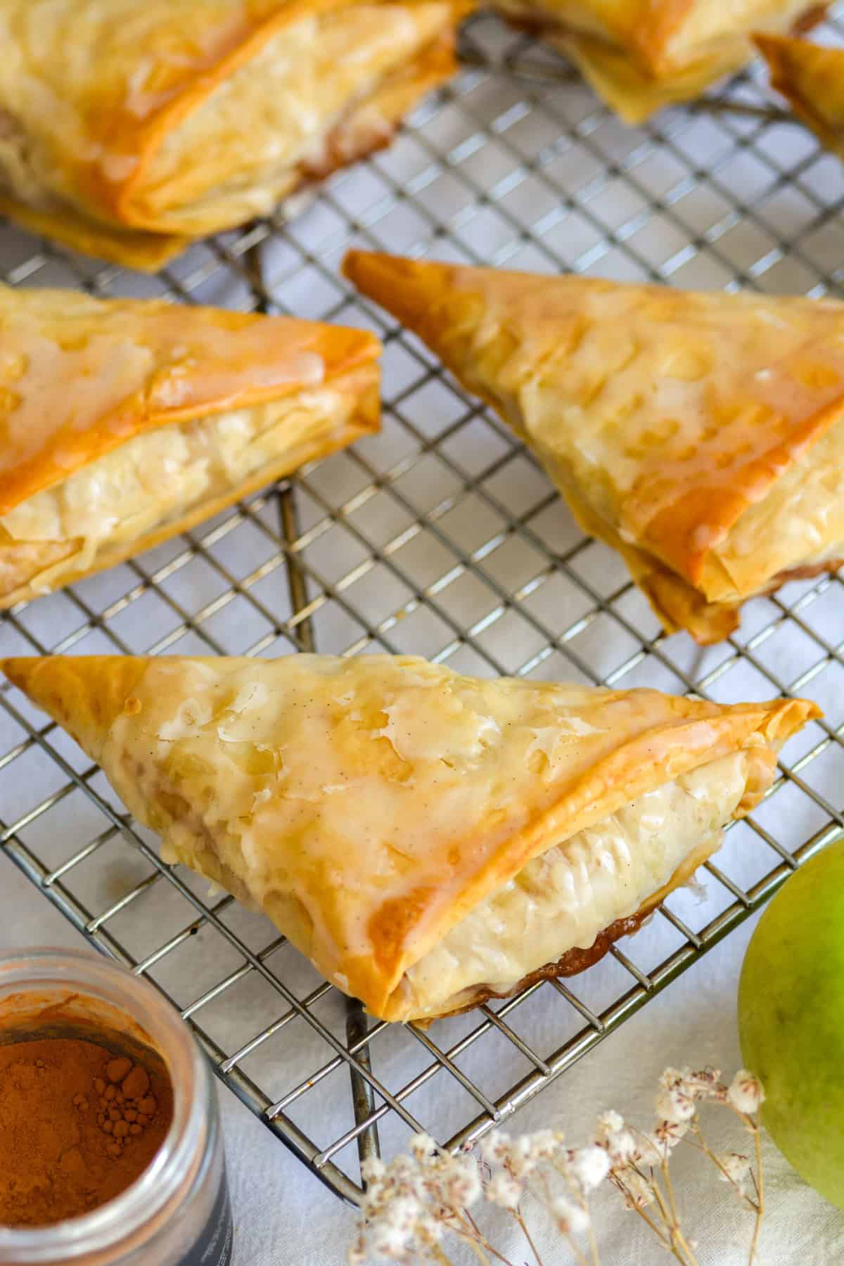 Apple Turnovers with Phyllo Dough on a wire cooling rack.