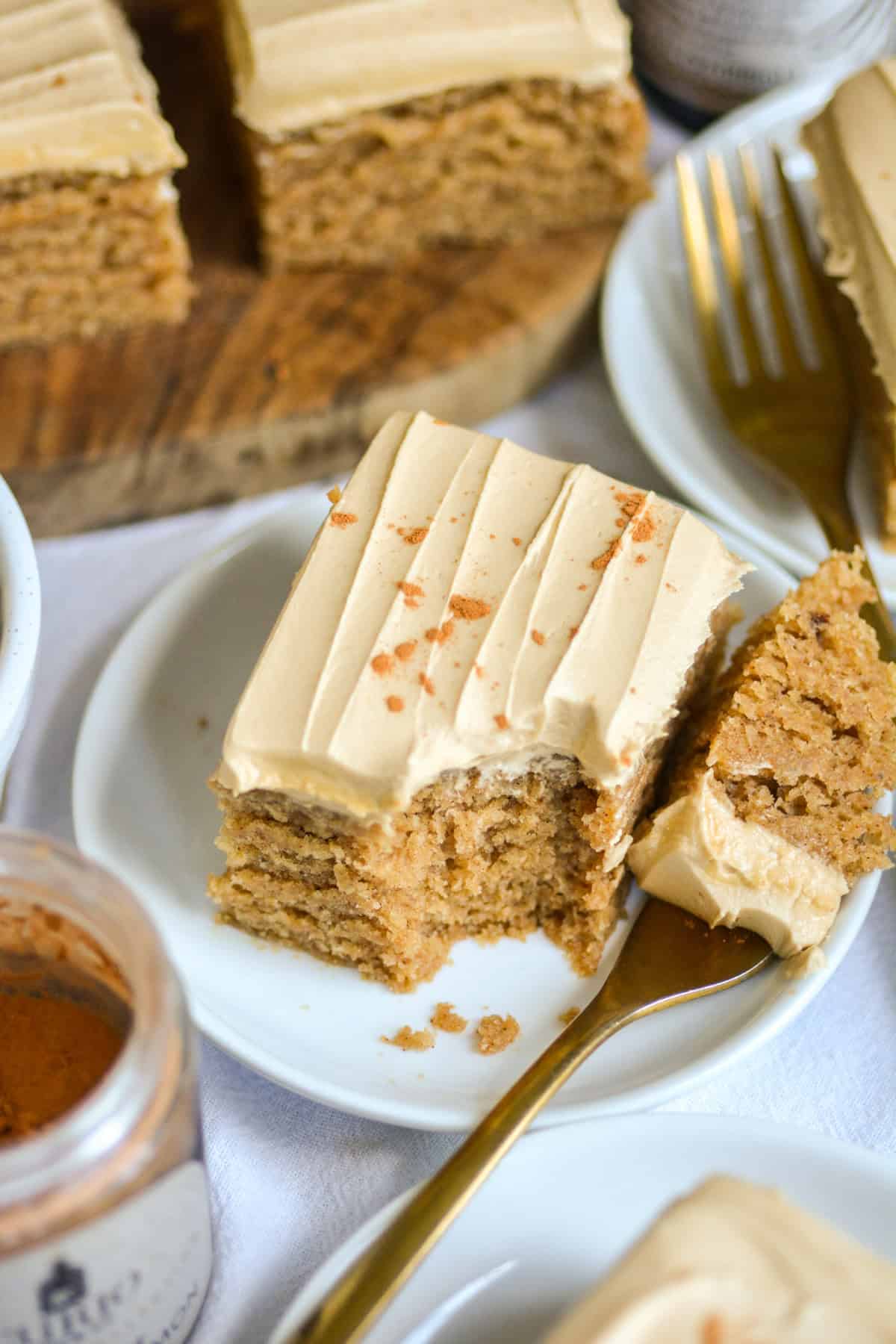Vegan Dirty Chai Spice Cake on a white plate with a gold fork.