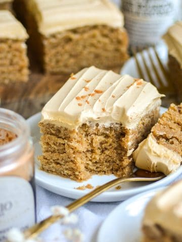 Dirty Chai Cake on a plate with a bite taken out of it.
