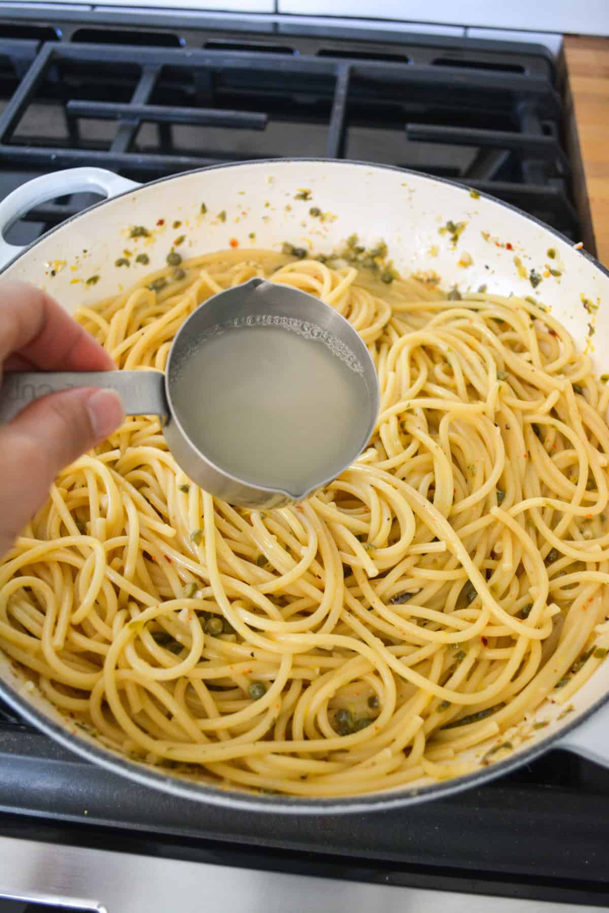 Pasta and pasta water added to the sauce.