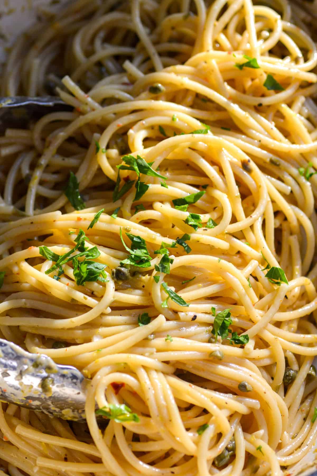 Vegan Lemon Caper Pasta in a large pan topped with parsley.