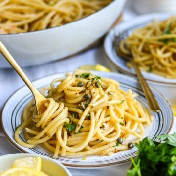 A plate of Vegan Lemon Caper Pasta topped with parsley.