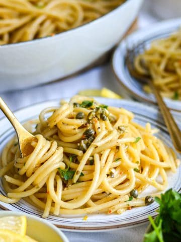 A plate of Vegan Lemon Caper Pasta topped with parsley.