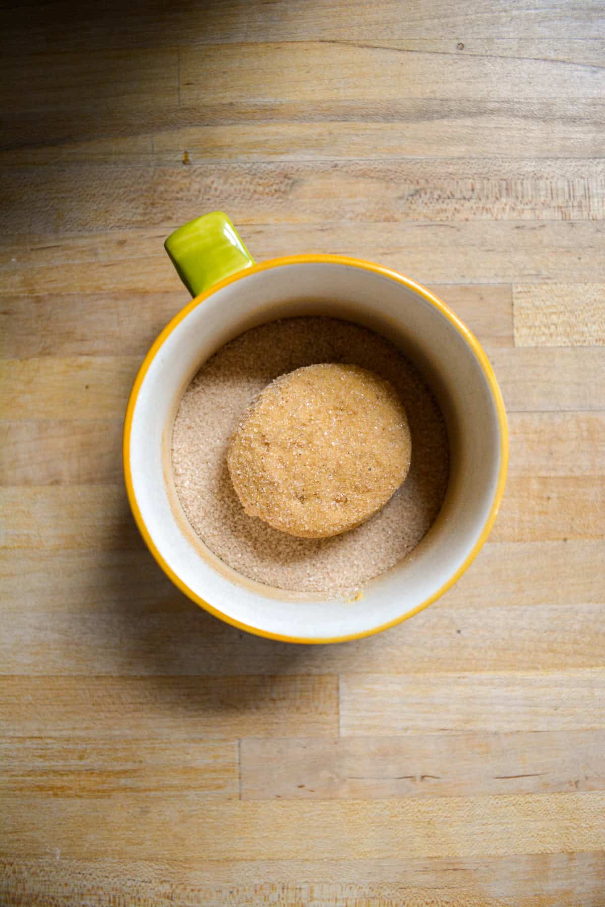 A cookie dough ball rolled in cinnamon sugar.