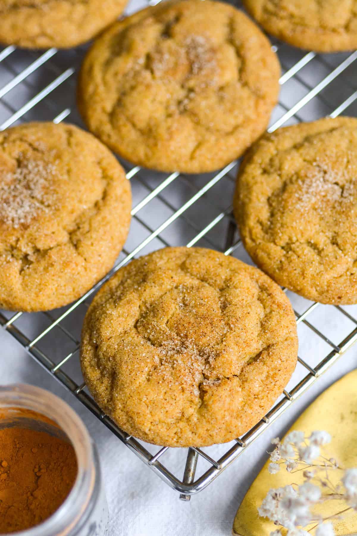 Vegan Pumpkin Snickerdoodles on a wire cooling rack.