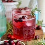 Cranberry Gin Cocktail in a glass garnished with a sprig of rosemary.