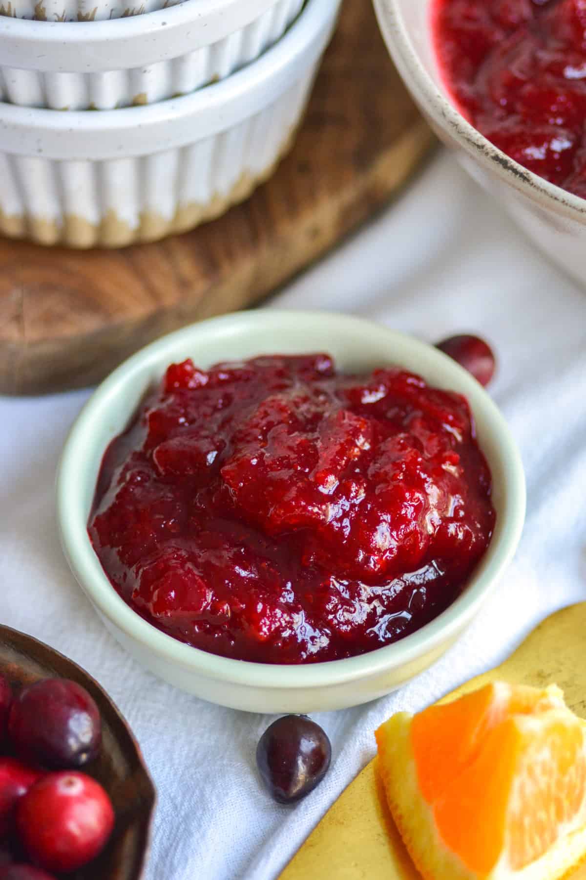 Orange Cranberry Sauce in a small bowl on a linen cloth.