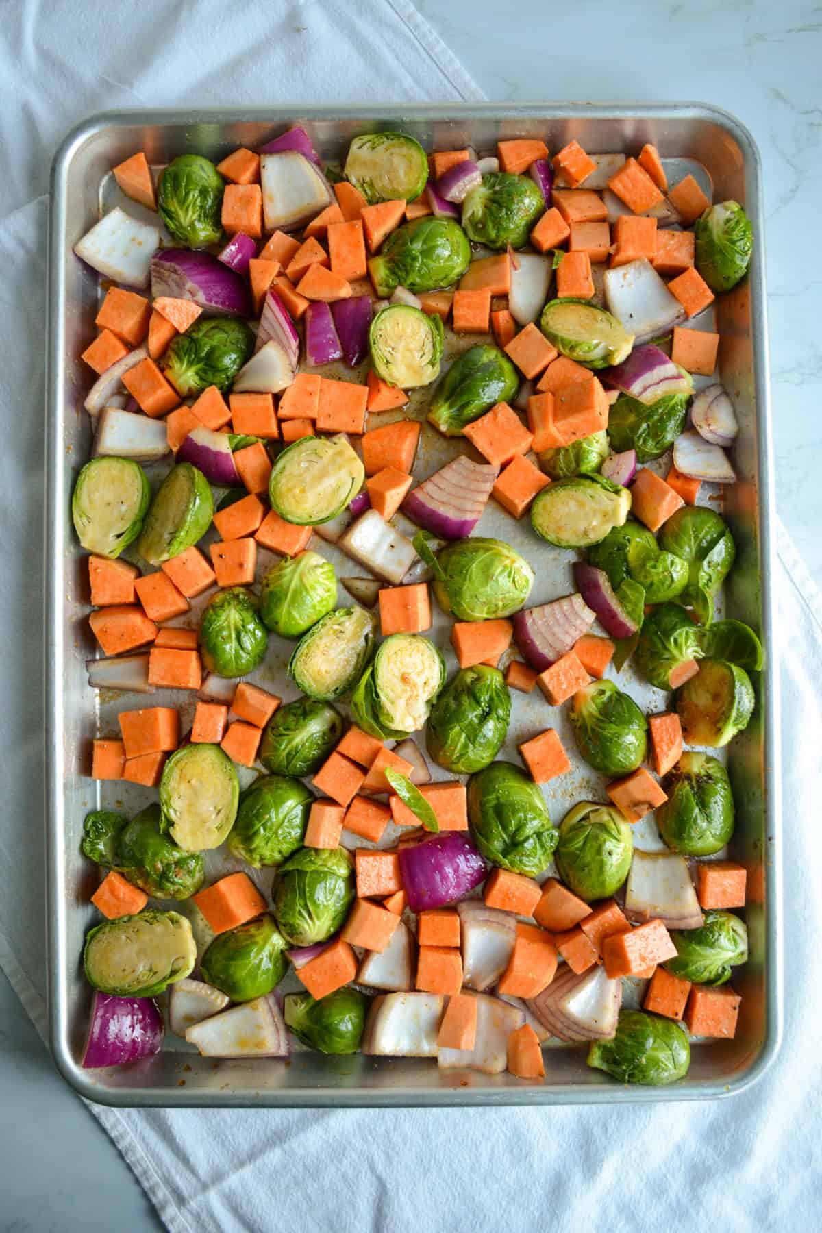 Vegetables on a baking sheet ready for the oven.