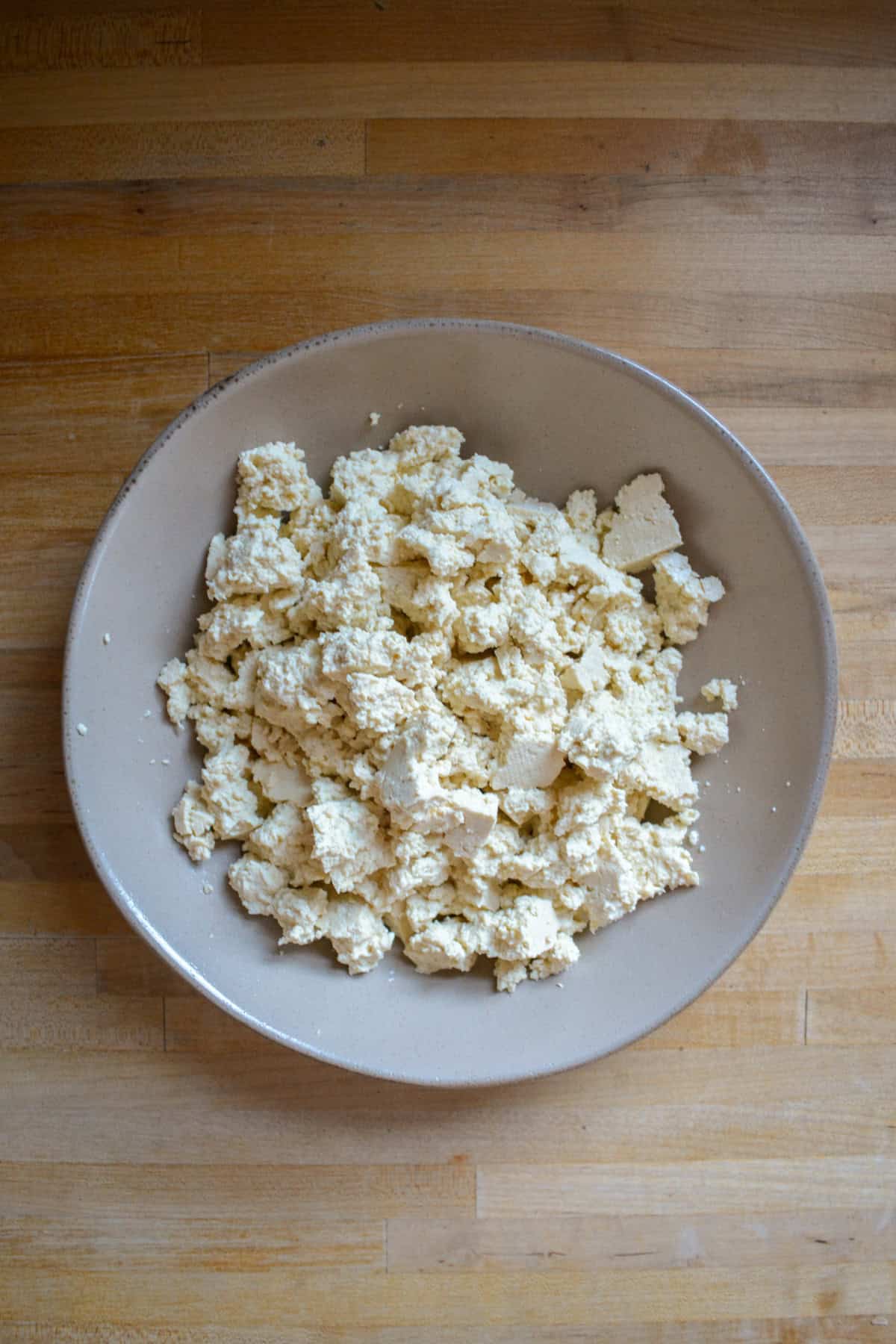 Crumbled tofu in a large bowl.