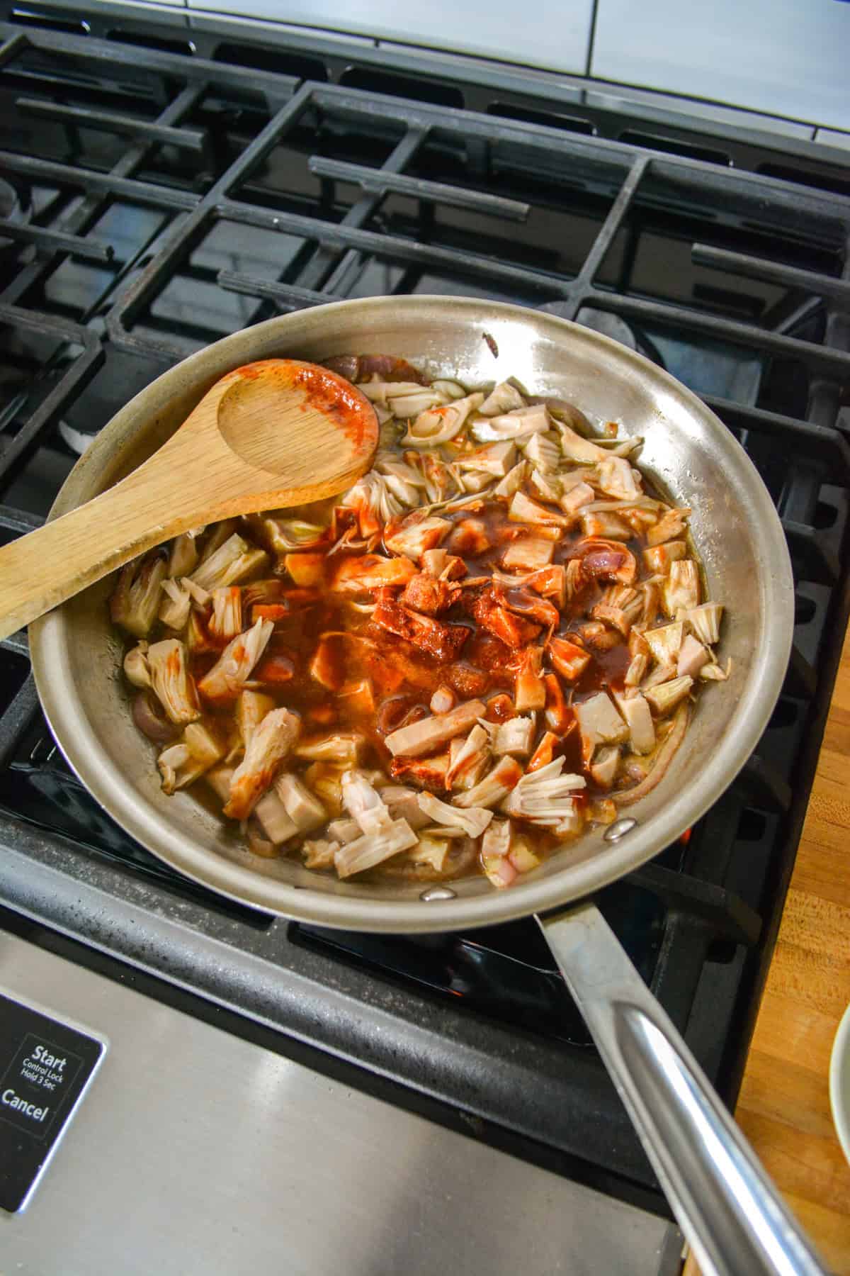 Barbecue sauce, jackfruit and spices added into the skillet.