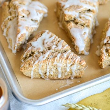 Vegan Banana Scone with vanilla glaze on a baking sheet.