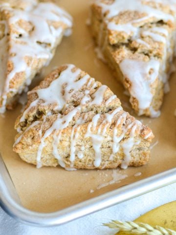 Vegan Banana Scone with vanilla glaze on a baking sheet.