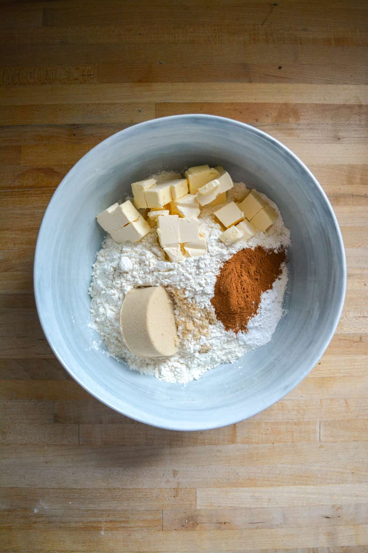 Flour, cinnamon, brown sugar and cubed butter in a large mixing bowl.