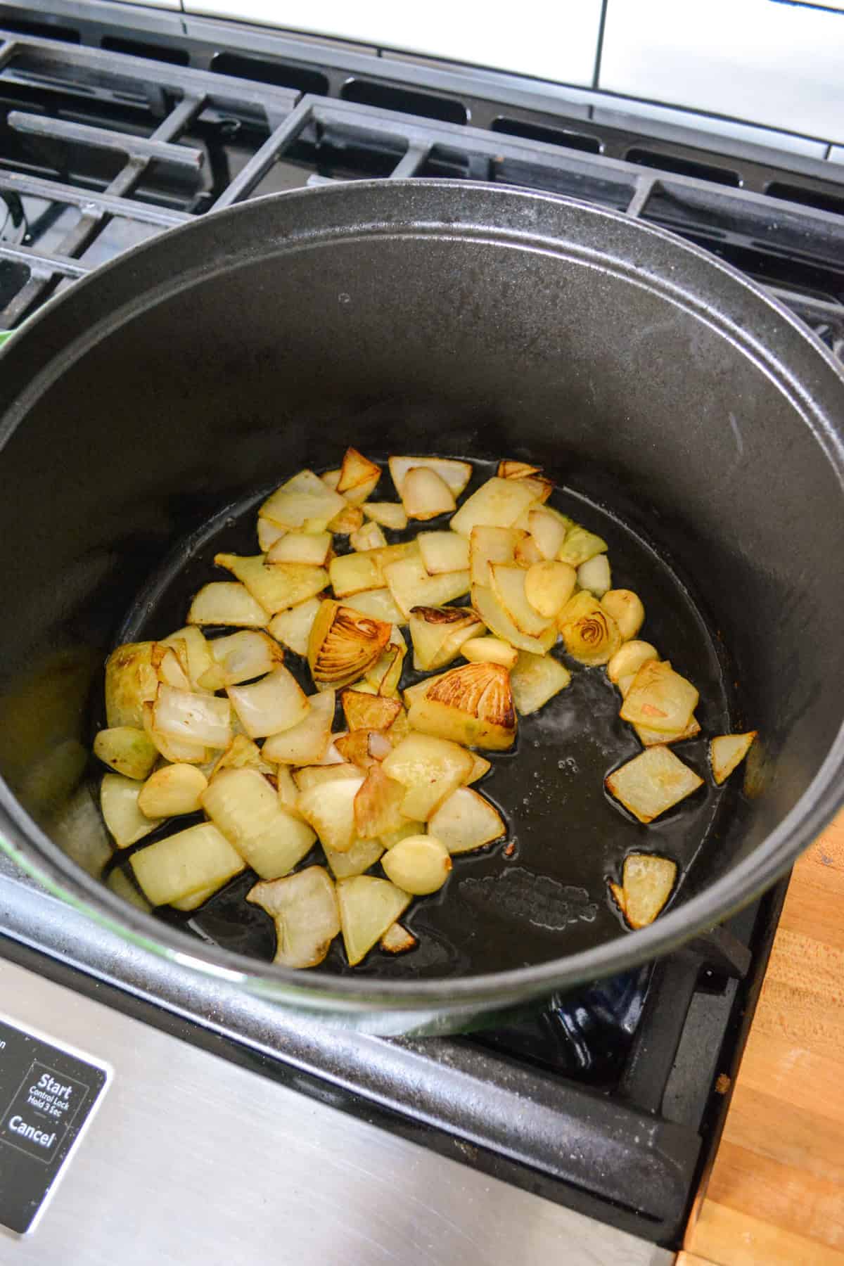 Onion and garlic browning in a large pot.