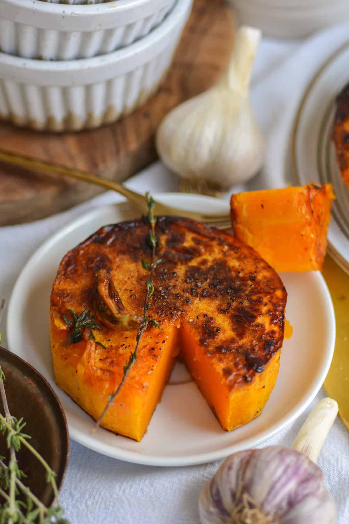 A Butternut Squash Steak with a piece cut out.