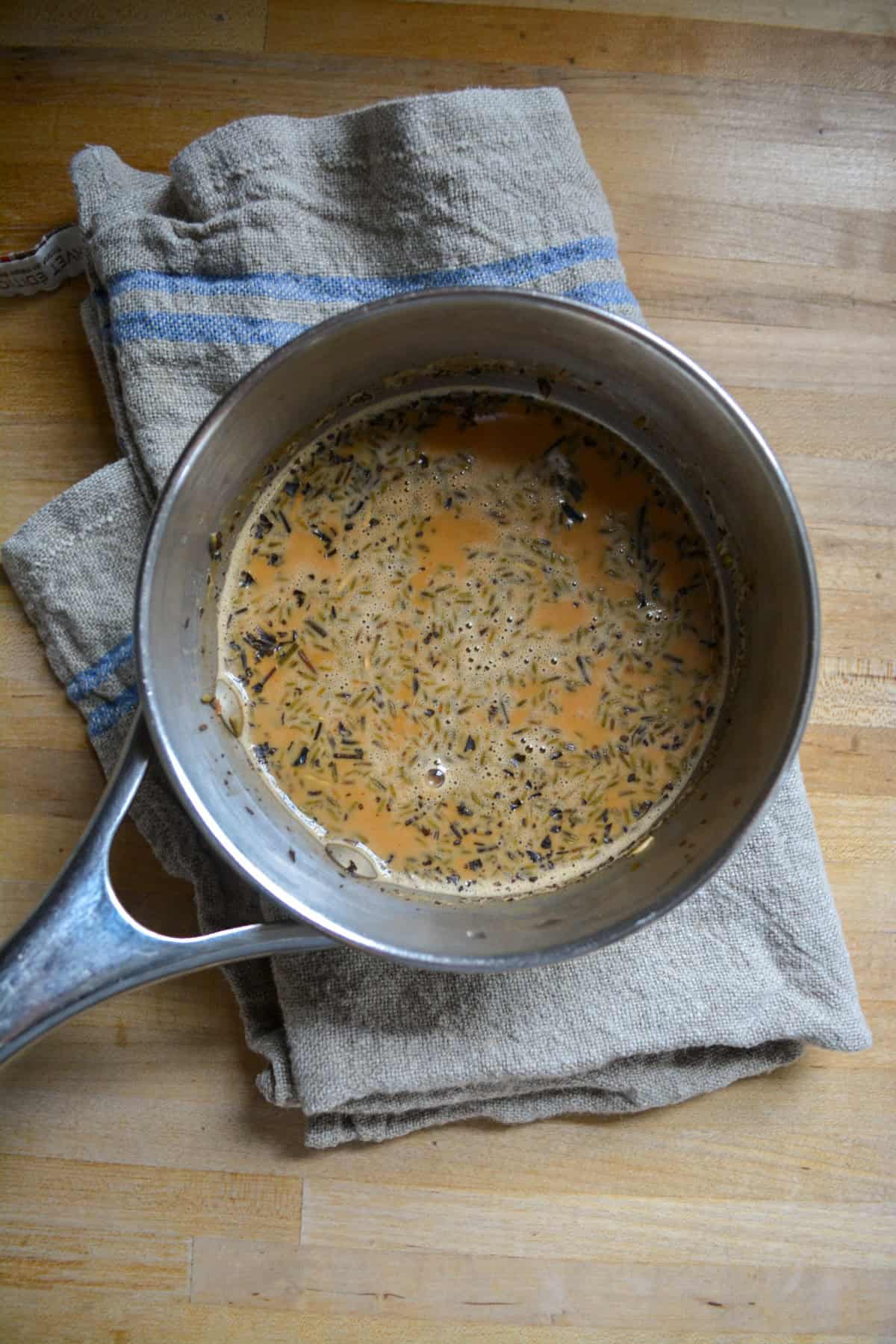 Tea steeped in milk in a saucepan.