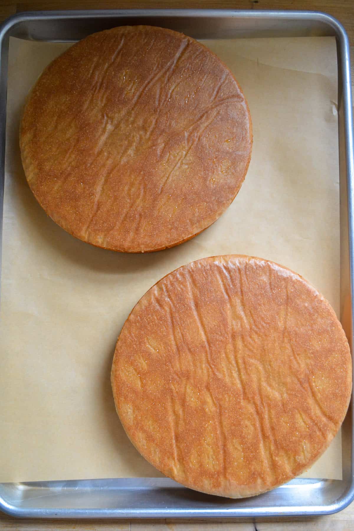 Earl Grey Lavender Cake layers turned onto a parchment-lined baking sheet.