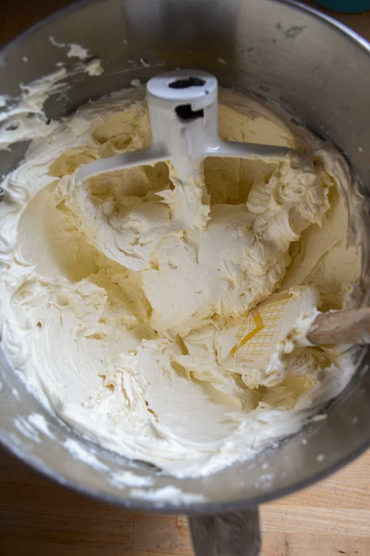 Vanilla bean frosting in a metal bowl.