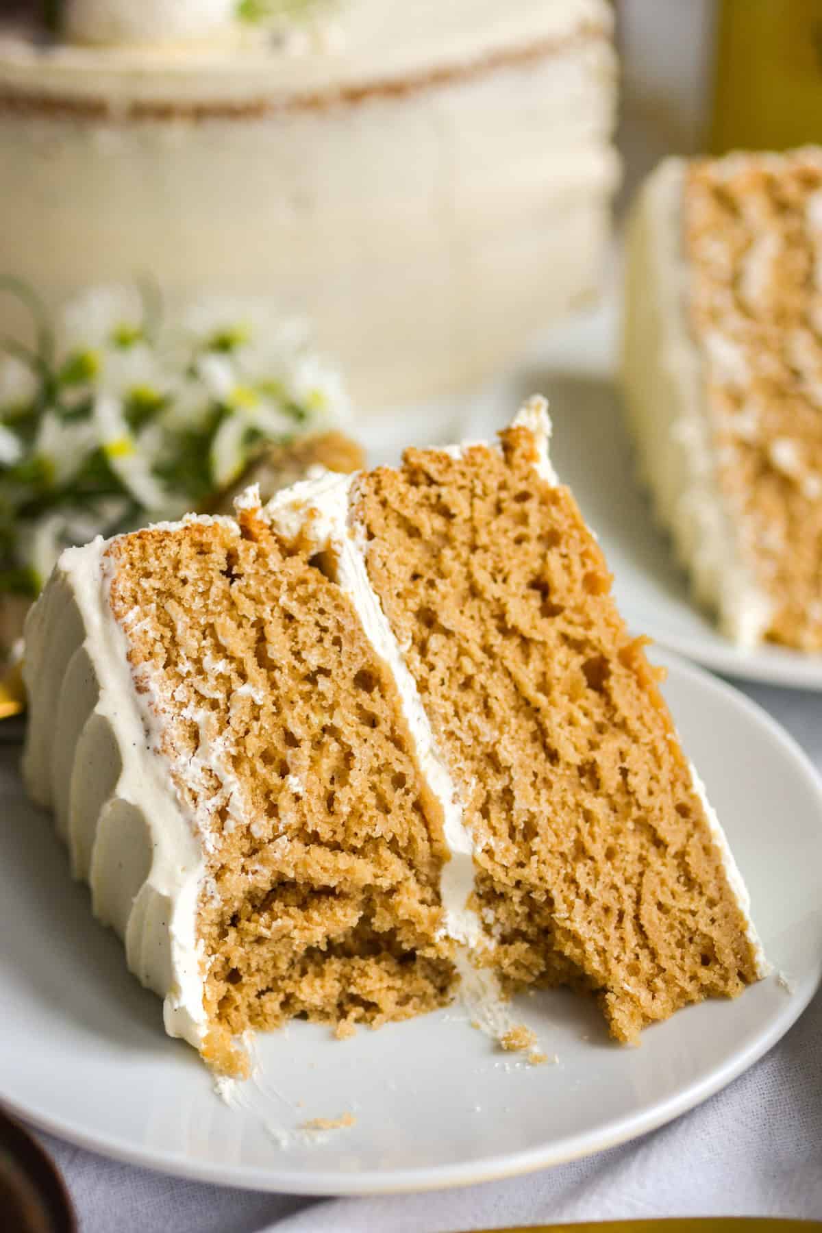 Earl Grey Lavender Cake with a bite taken out of it on a small white plate.