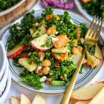 Kale Sweet Potato Salad on a plate with a gold fork.