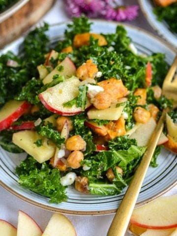 Kale Sweet Potato Salad on a plate with a gold fork.