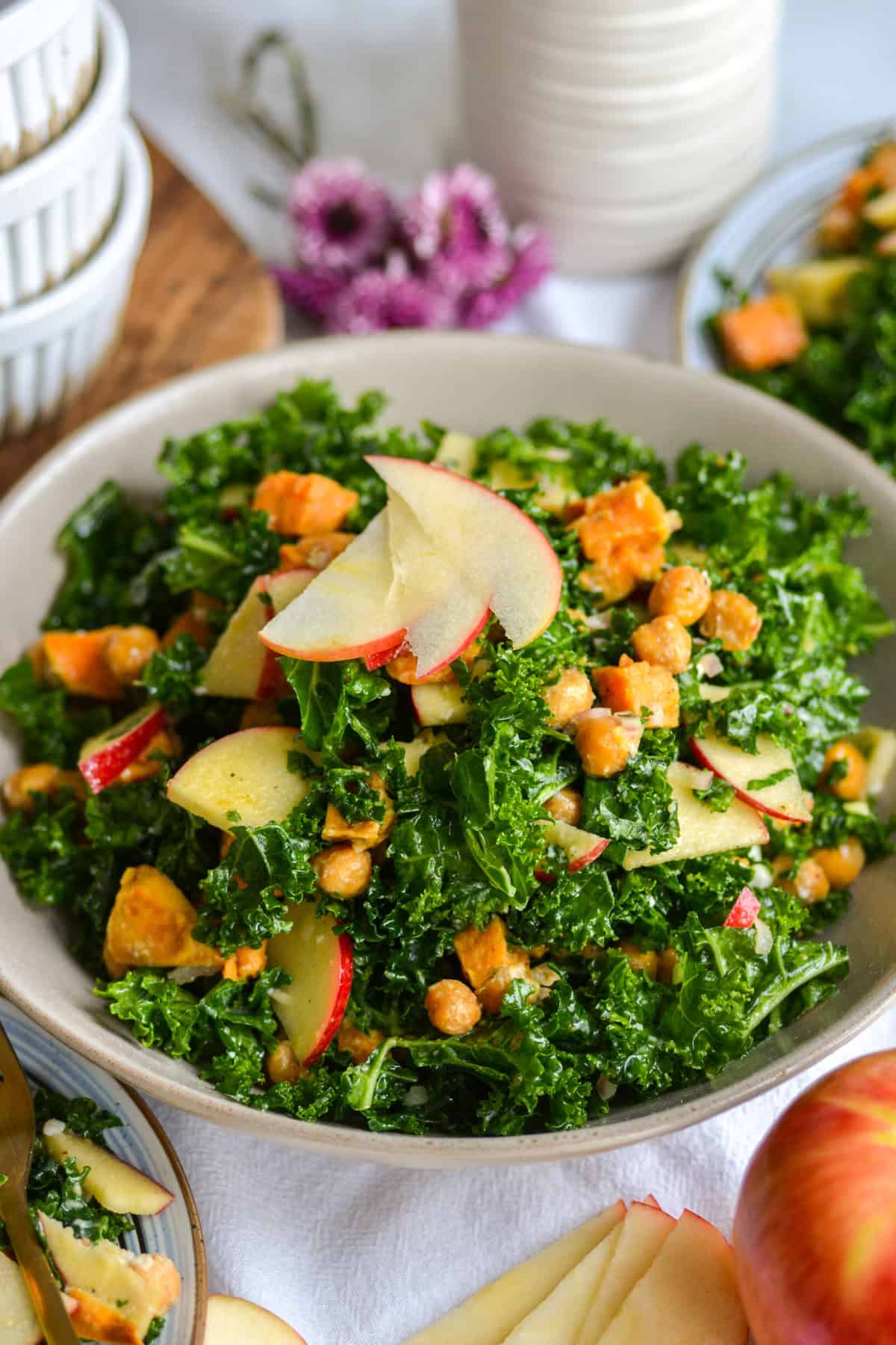 Kale Sweet Potato Salad in a large bowl topped with sliced apple.