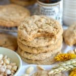 A stack of Peanut Butter Banana Cookies with a bite taken out of the top cookie.
