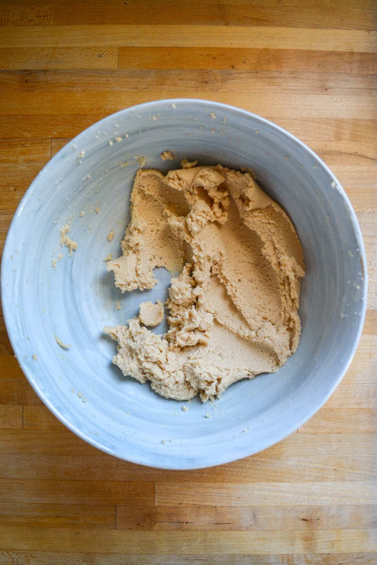 Vegan butter and brown sugar creamed together in a large mixing bowl.