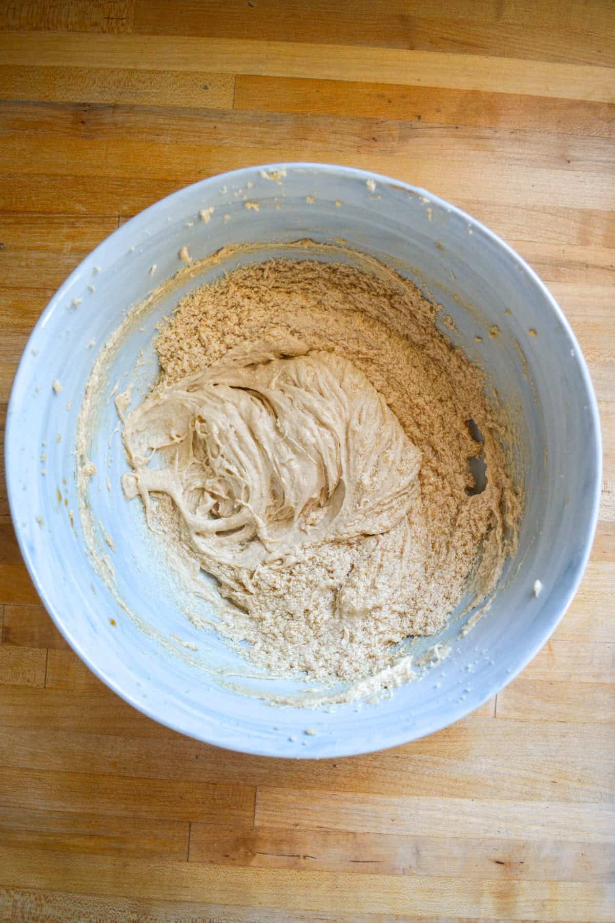 Non-dairy milk and vanilla added into the bowl.