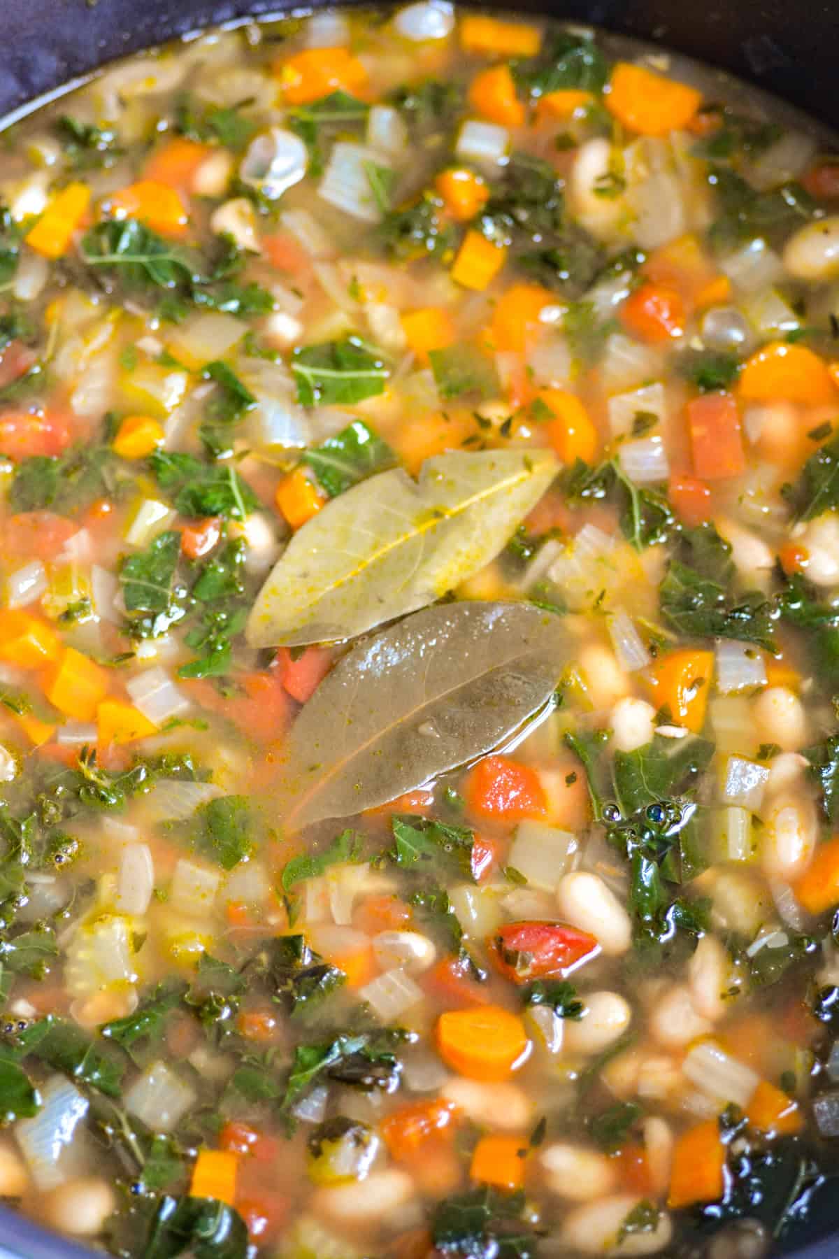 Vegan Tuscan White Bean Soup with Kale in a pot.