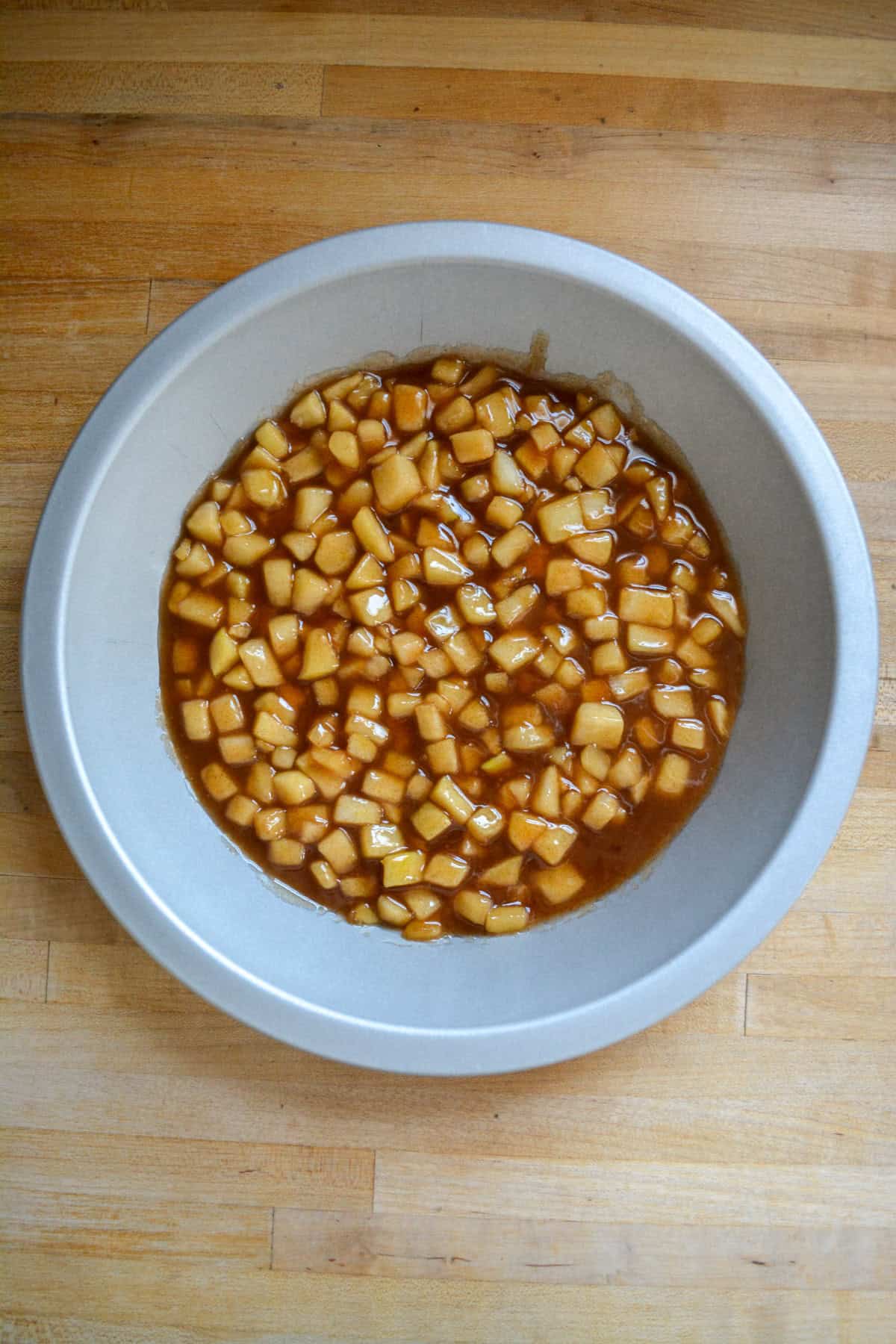 Apple pie filling in a deep-dish pie plate.