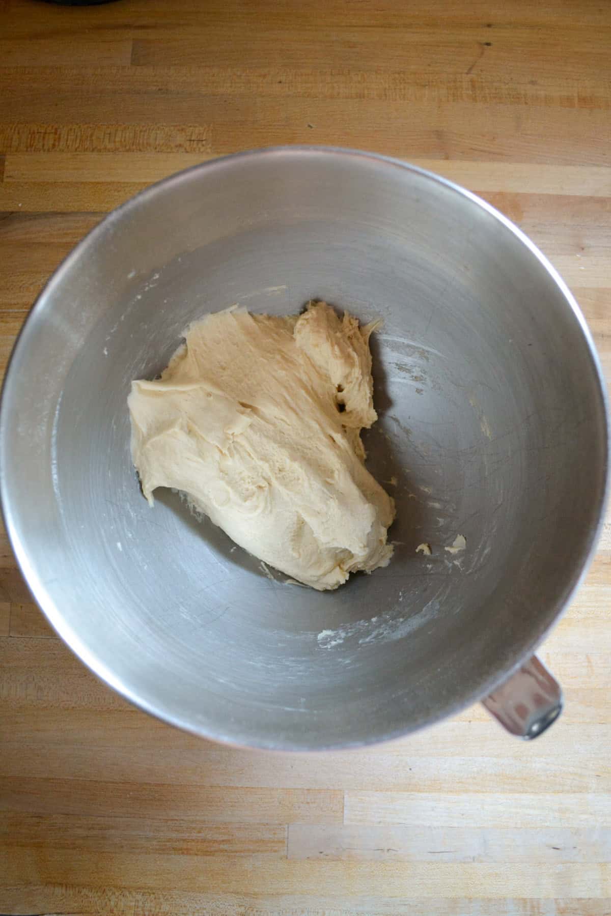 Dough in the bowl of a stand mixer.
