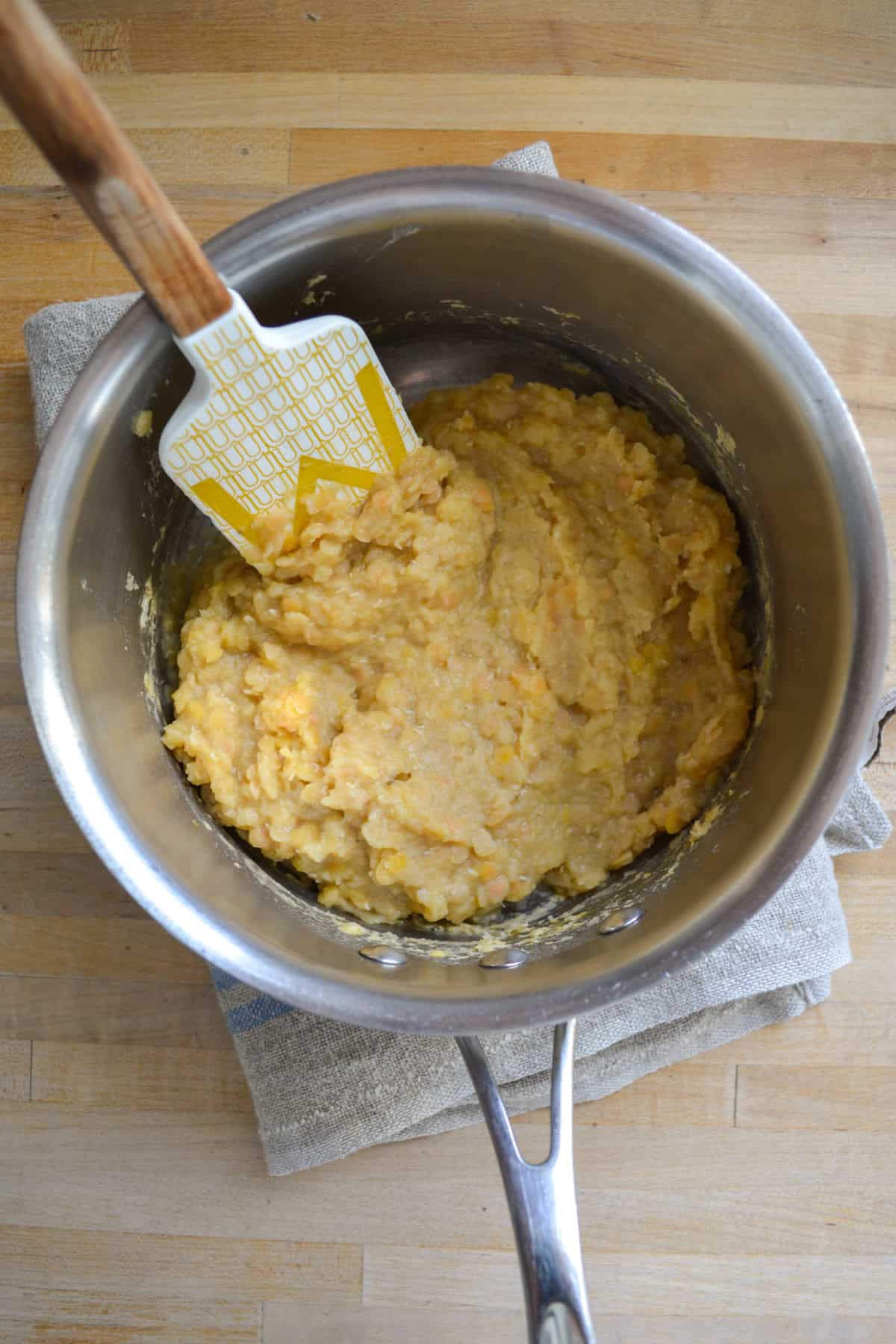 Cooked red lentils in a sauce pan.