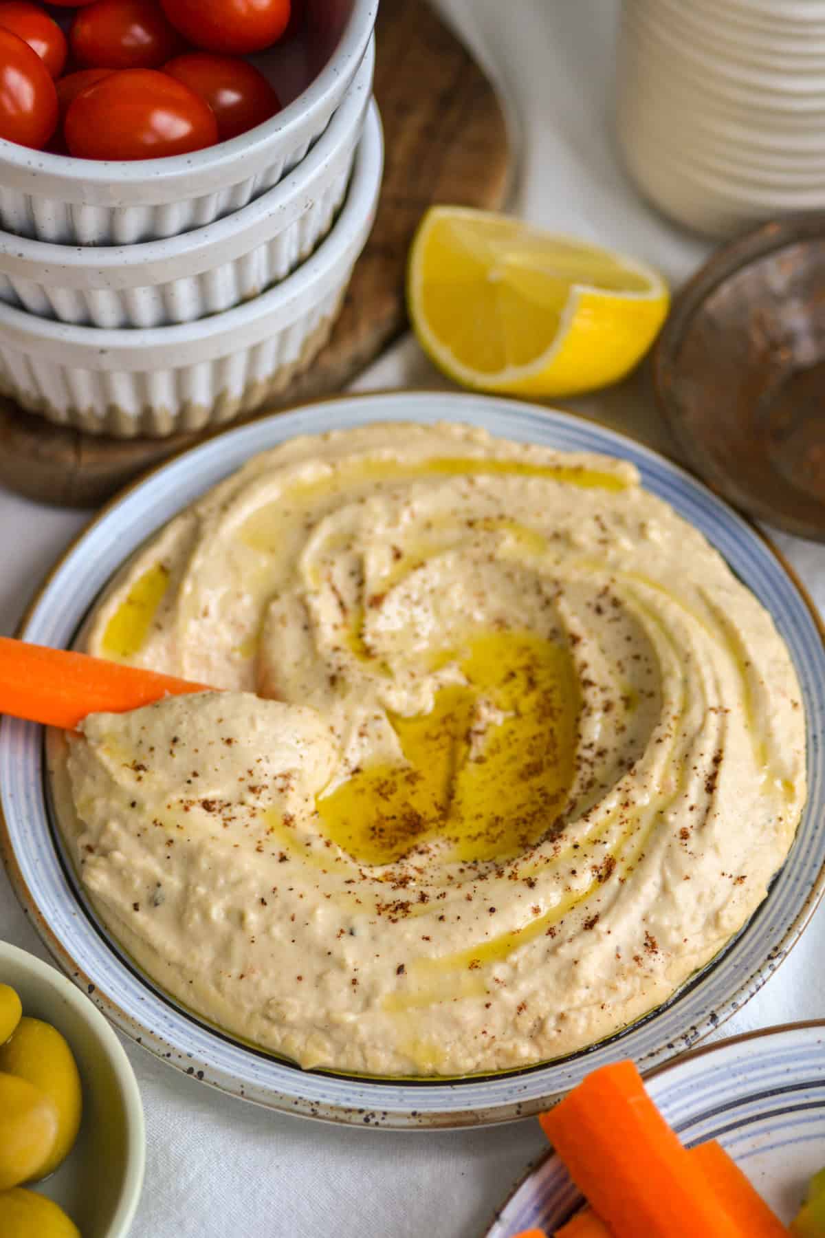 Red Lentil Hummus on a plate drizzled with extra virgin olive oil.
