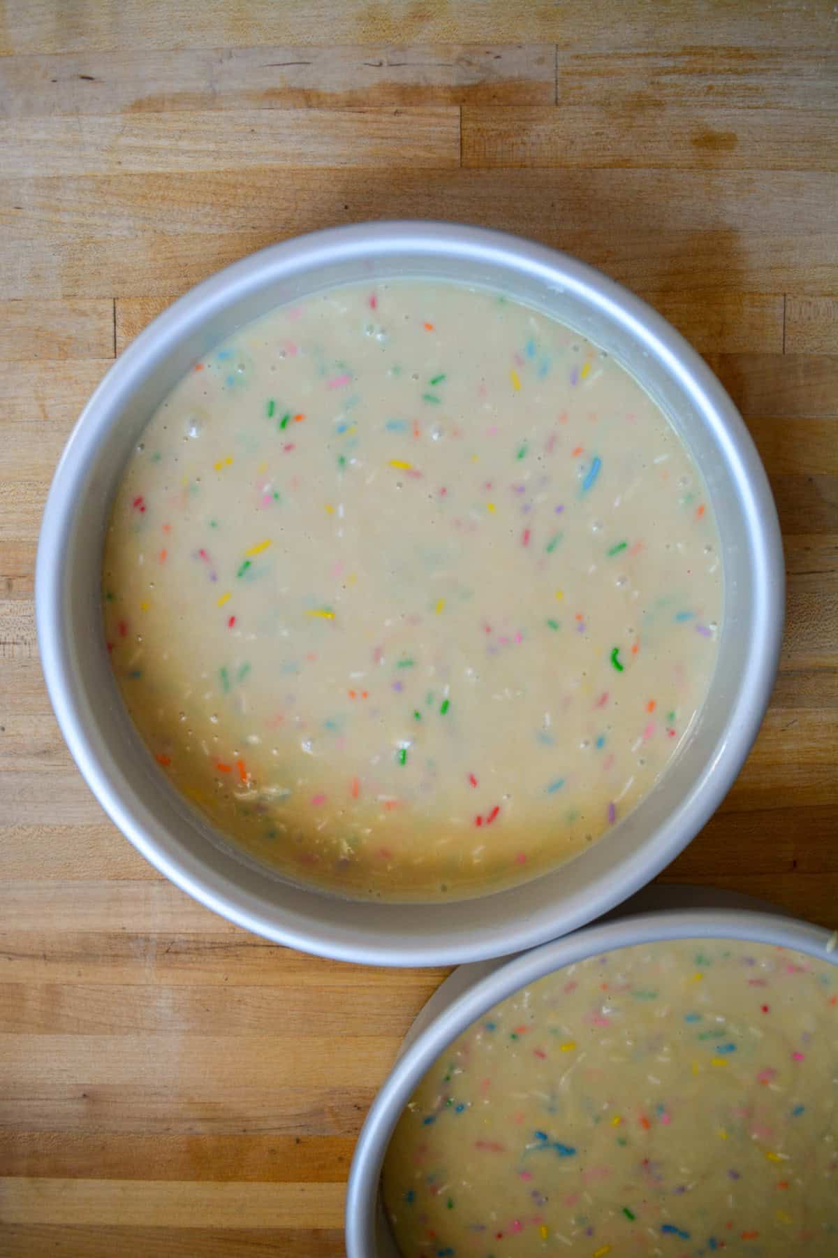 Cake batter poured into in prepared round cake pans.