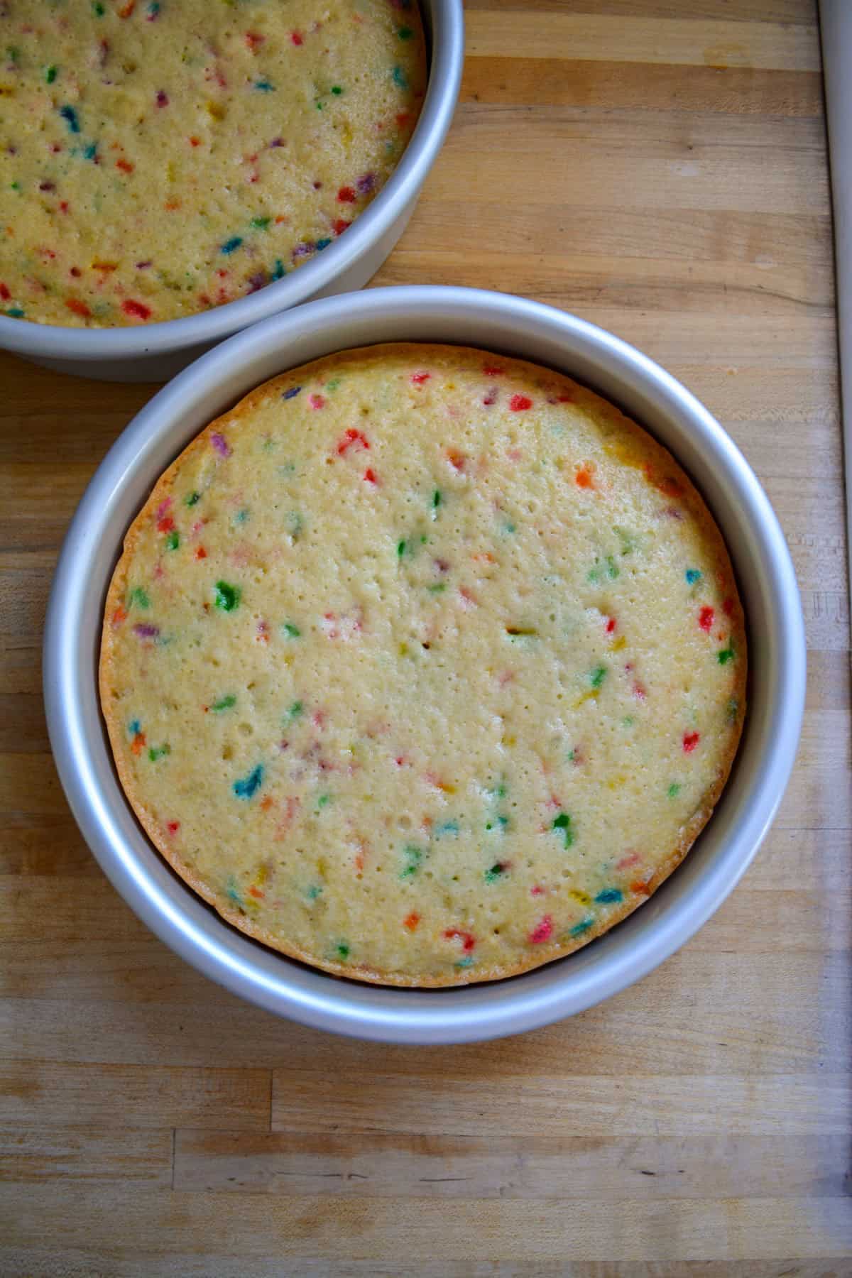 Baked cake layers in their cake pans.