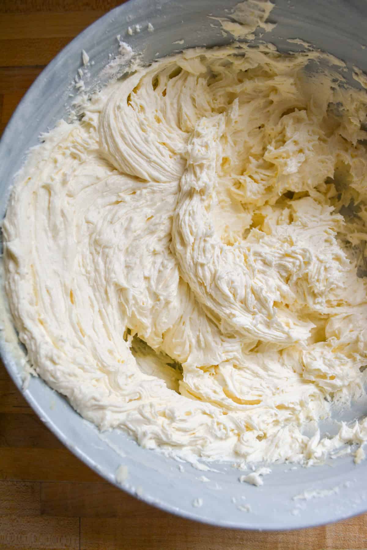 Vegan vanilla frosting in a large mixing bowl.