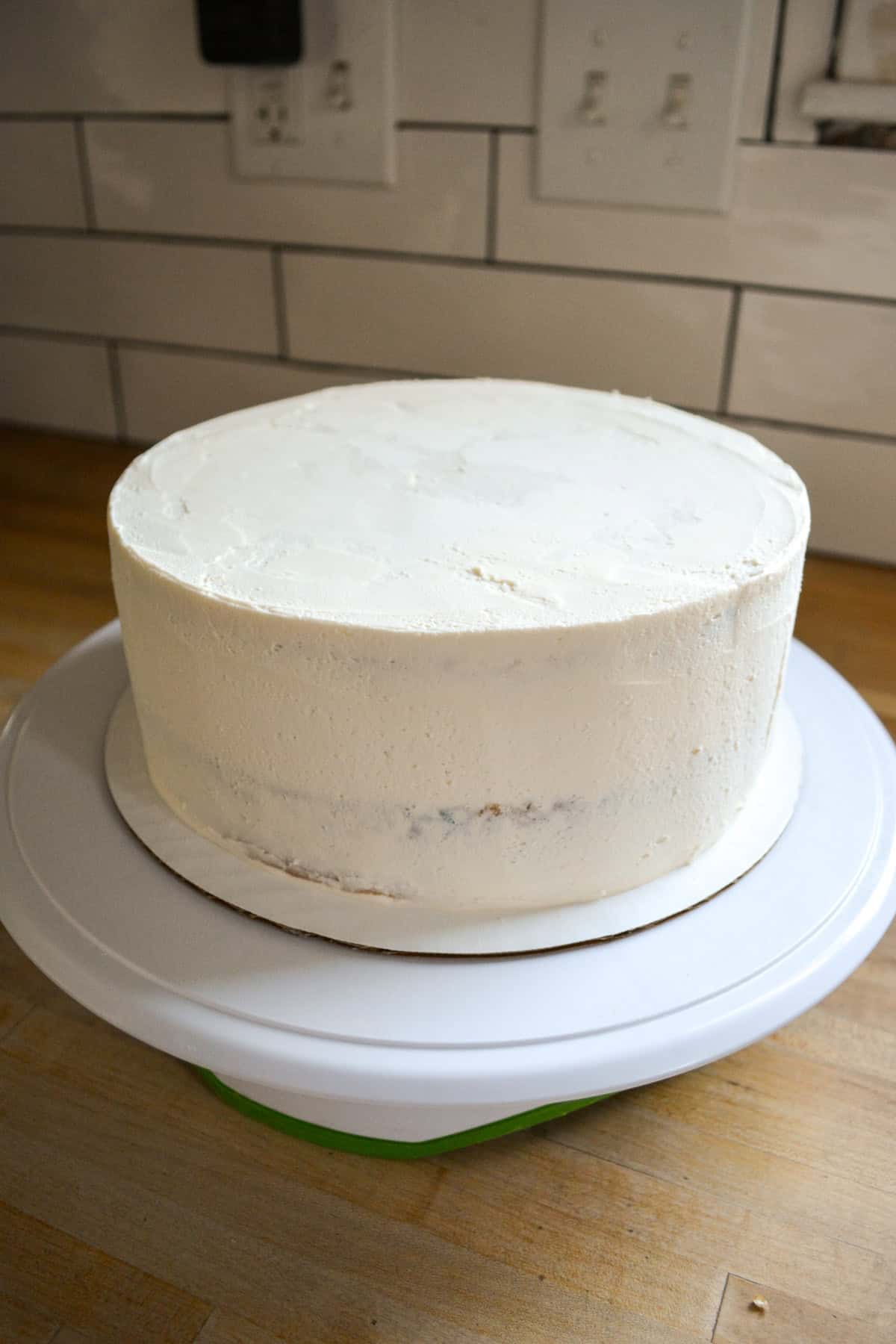 A frosted layer cake on a cake stand.