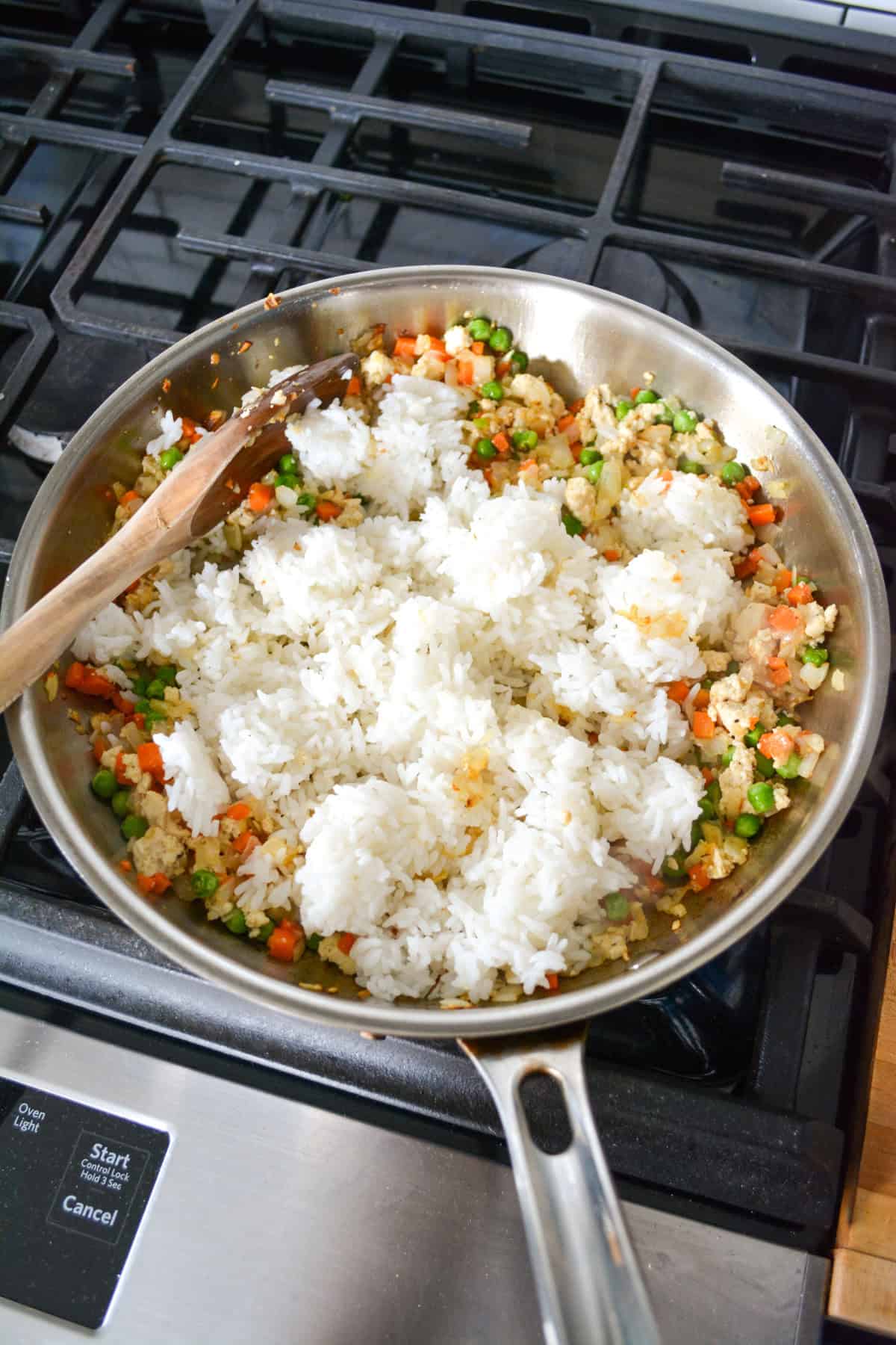 Cooked rice added into the skillet.