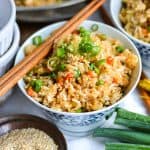 Vegan Fried Rice in a small bowl with chopsticks on top.