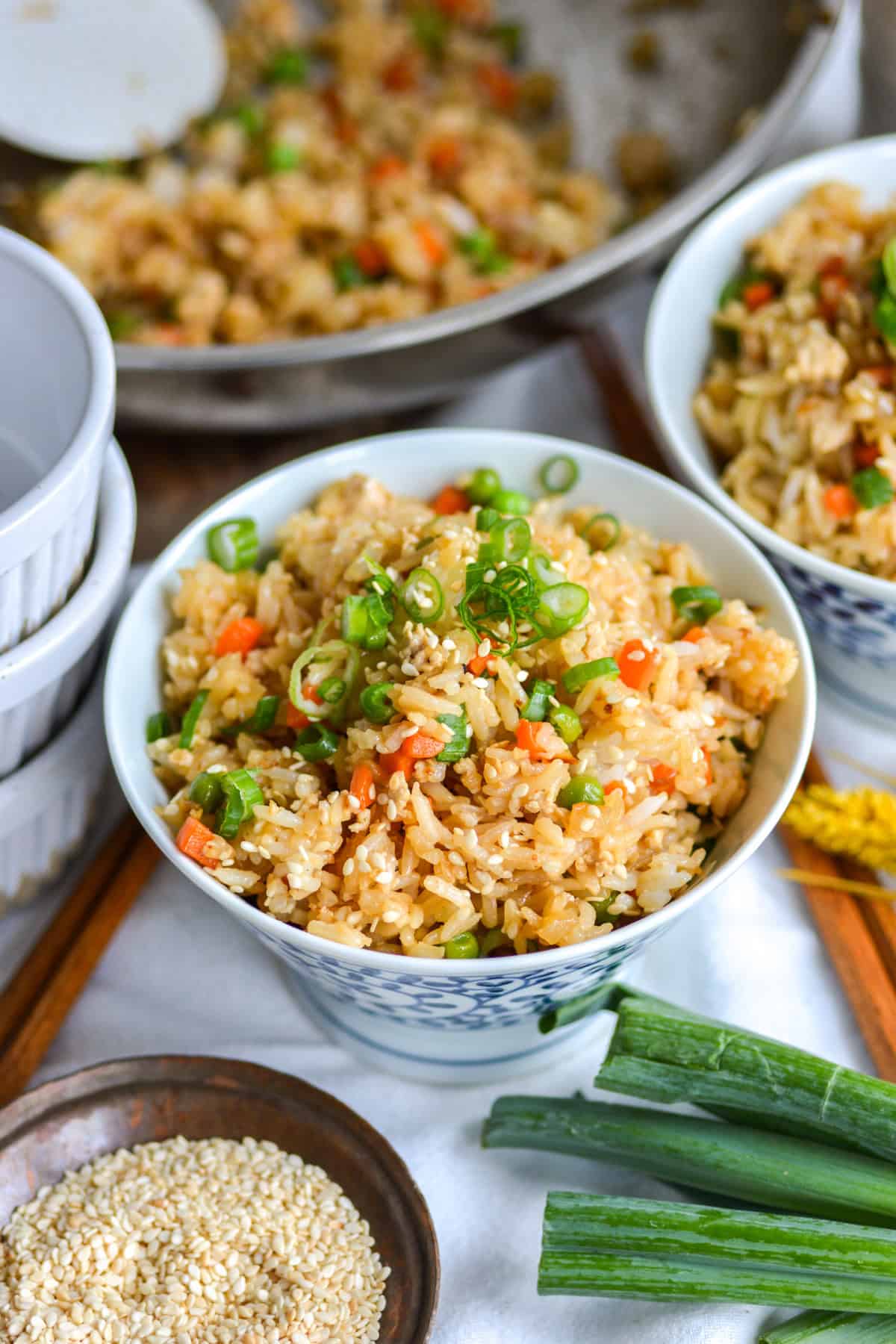Vegan Fried Rice in a bowl topped with scallions and sesame seeds.