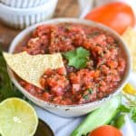 Homemade Vitamix Blender Salsa in a bowl with a tortilla chip in it.