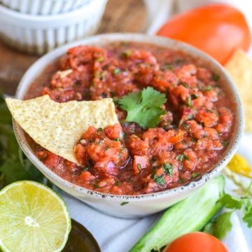Homemade Vitamix Blender Salsa in a bowl with a tortilla chip in it.