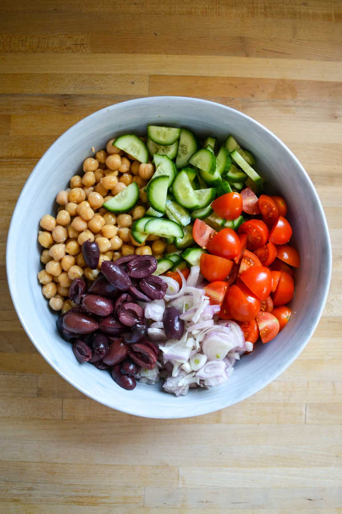 Ingredients for the barley salad in a large mixing bowl.