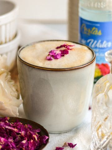 Rose Water Latte in a mug on a linen surface.