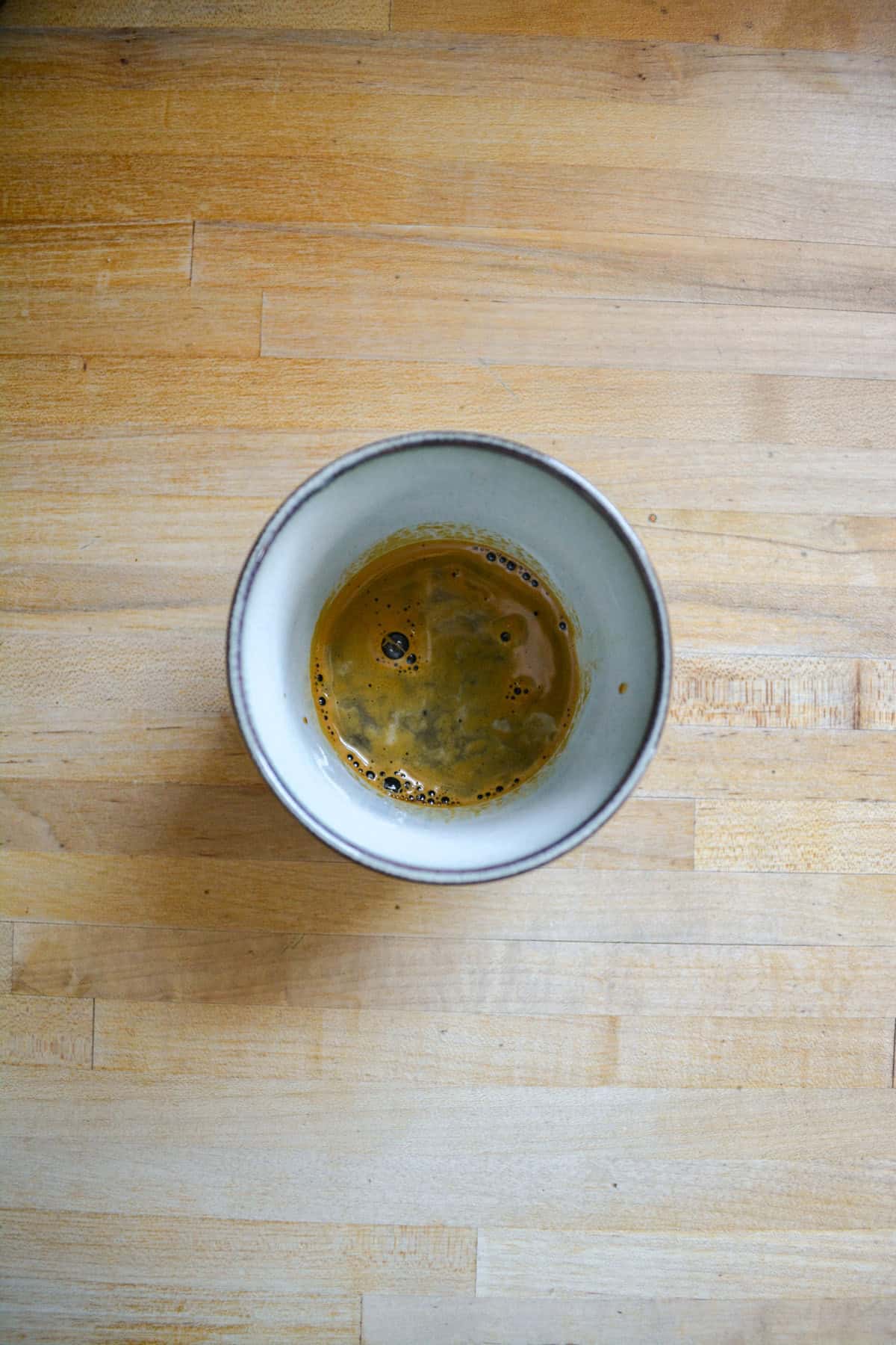 Espresso in the bottom of a mug.